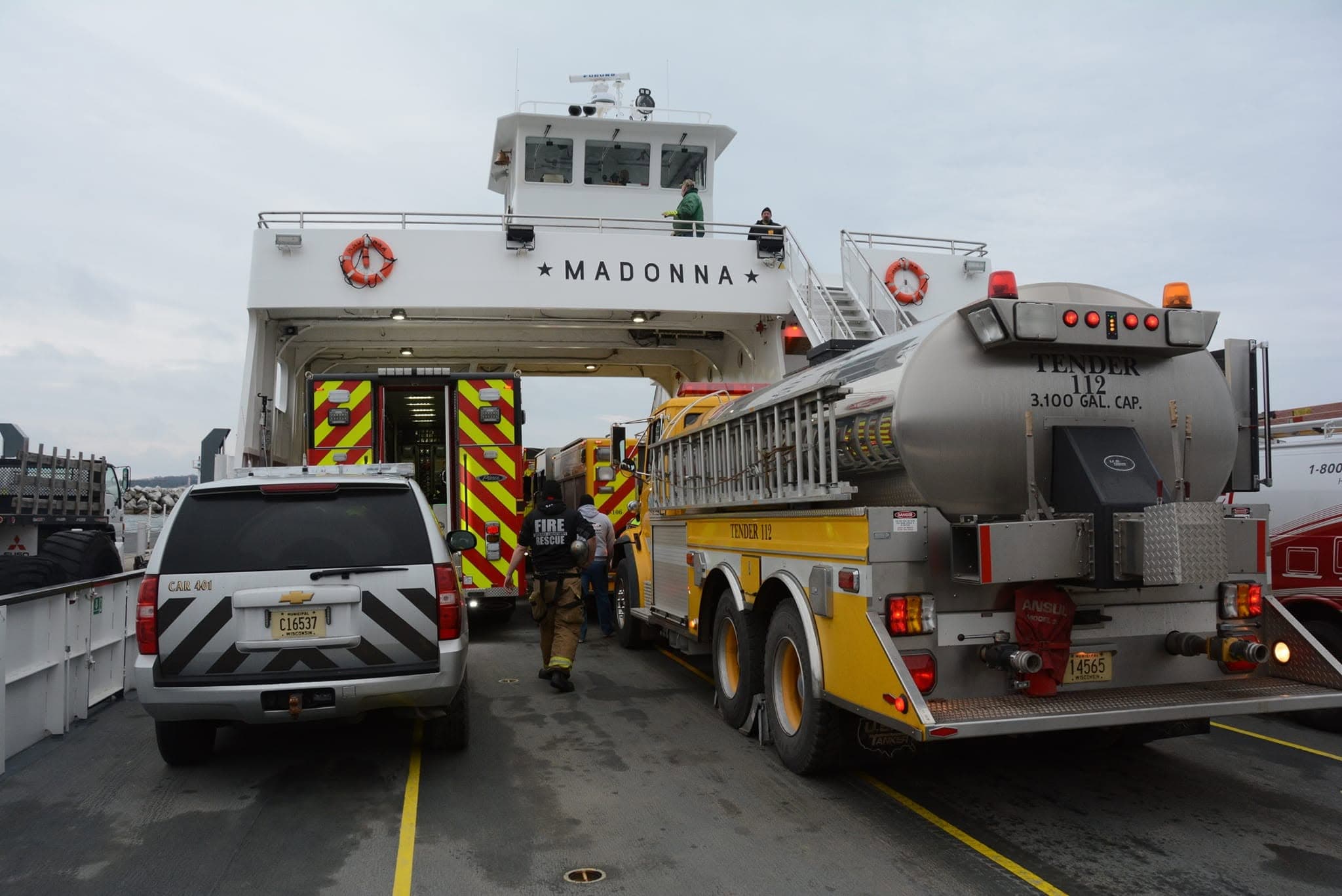 Firefighters and emergency vehicles positioned closely together on the ferry Madonna